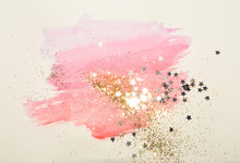Golden Glitter And Glittering Stars On Abstract Pink Watercolor Splash In Vintage Nostalgic Colors.