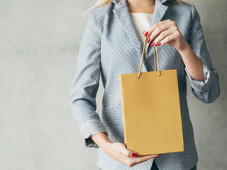 brown paper bag in woman hands. presents shopping concept.