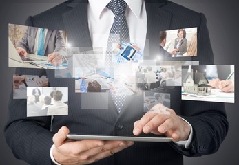 Poster - Businessman holding digital tablet and working on