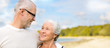 © Syda Productions - old age, retirement and people concept - happy senior couple hugging over beach background