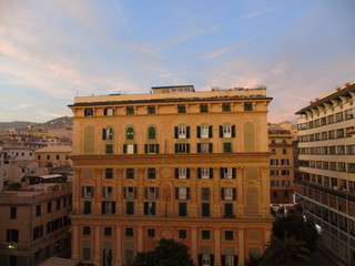 An amazing caption of the city of Genoa in the afternoon with an amazing sky and clouds and some street lights in autumn