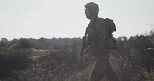 Slow Motion Of An Israeli Soldier Walking With A Rifle On A Sand Hill