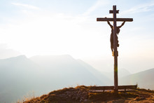 Wooden Crucifix With Jesus On A Mountain Hill