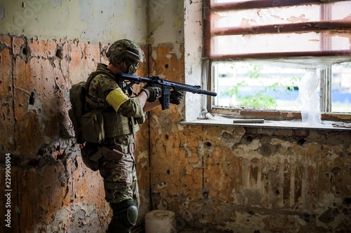 Cuadros en Lienzo sniper with automatic rifle by the window in building