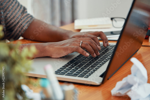 Fotografía Faceless shot of modern black businesswoman working on laptop and typing on keyb