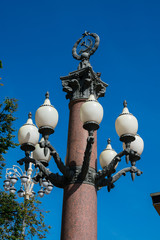 Wall Mural - Soviet symbol over a street lamp, a star and hammer crossed with a sickle. Pushkin Square. Moscow, Russia