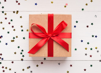 Wall Mural - Brown gift box with red bow on white background