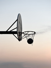 Silhouette Of A Basketball Hoop And Backboard At Sunset