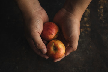 Man holding wild apple in hands