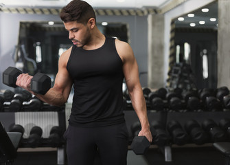 Poster - Arab man training with dumbbell in modern gym