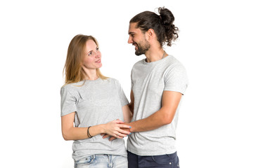 Wall Mural - Portrait of happy couple on white background. Couple in love, man and woman hugging and look at each other.