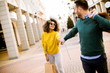 © BGStock72 - Young smiling couple shopping in an urban street