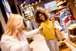 © BGStock72 - Two pretty young women choosing clothes from new collection in department store