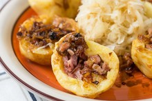 Potato dumplings with smoked meat and fried onion,cabbage.