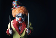 Halloween. Scary Clown With Knives. 