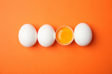 Raw chicken eggs on color background, top view