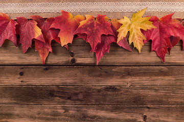 Wall Mural - Fall and autumn maple leaves decoration on a wooden table, top view. Copy space.