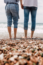 Couple Standing Together In The Shallow Sea Water