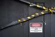 © Stocksy - Close up of do not enter construction zone and danger sign on black wall with tape