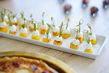 Wall Mural - Delicious baked pineapple and mozzarella snacks served on a party or wedding reception.