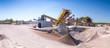 Crushing machinery, cone type rock crusher, conveying crushed granite gravel stone in a quarry open pit mining. Processing plant for crushed stone and gravel. Mining and Quarry mining equipment.