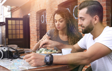 Wall Mural - Portrait of lovely romantic couple sitting in a cafe with coffee