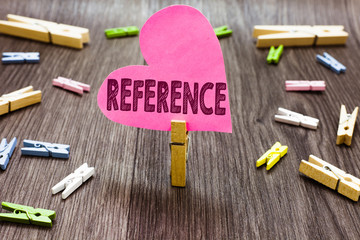 Poster - Writing note showing Reference. Business photo showcasing Mentioning or alluding to something Recommendation Mention Clothespin holding pink paper heart several clothespins wooden floor