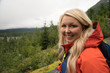 © MelissaMN - Female hiker wearing a rain jacket enjoys the views in Seward Alaska in the wilderness of Kenai Fjords National Park