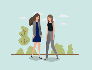 Wall Mural - elegant businesswomen walking in the park