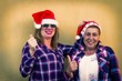 © tetxu - portrait of senior women with santa claus cap and thumb raised with ok symbol