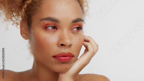 Mixed Race Black Blonde Model With Curly Hair And Red Makeup