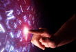 © ra2 studio - Female finger touching a beam of light surrounded by a pink background with alphabet letters