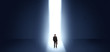 © ra2 studio - Businessman standing and seeing the light at the end of a big wall