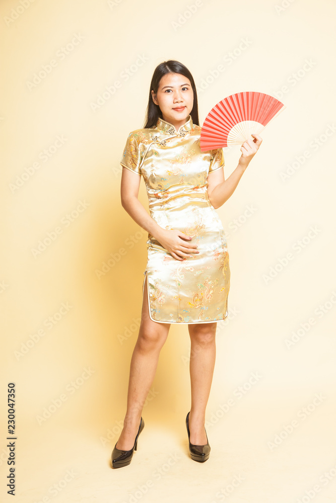 Asian girl in golden chinese cheongsam dress Stock Photo | Adobe Stock