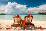 Fototapeta Morze - Couple on a beach at christmas