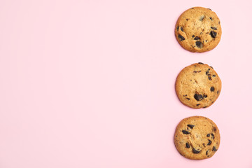 Poster - Delicious chocolate chip cookies on color background, flat lay. Space for text