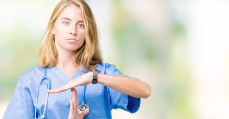 Beautiful young doctor woman wearing medical uniform over isolated background Doing time out gesture with hands, frustrated and serious face