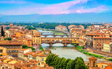 Panoramic view of medieval stone bridge Ponte Vecchio over Arno river in Florence (Firenze), Tuscany, Italy, Europe. Florence cityscape. Architecture and landmark of Florence and Italy