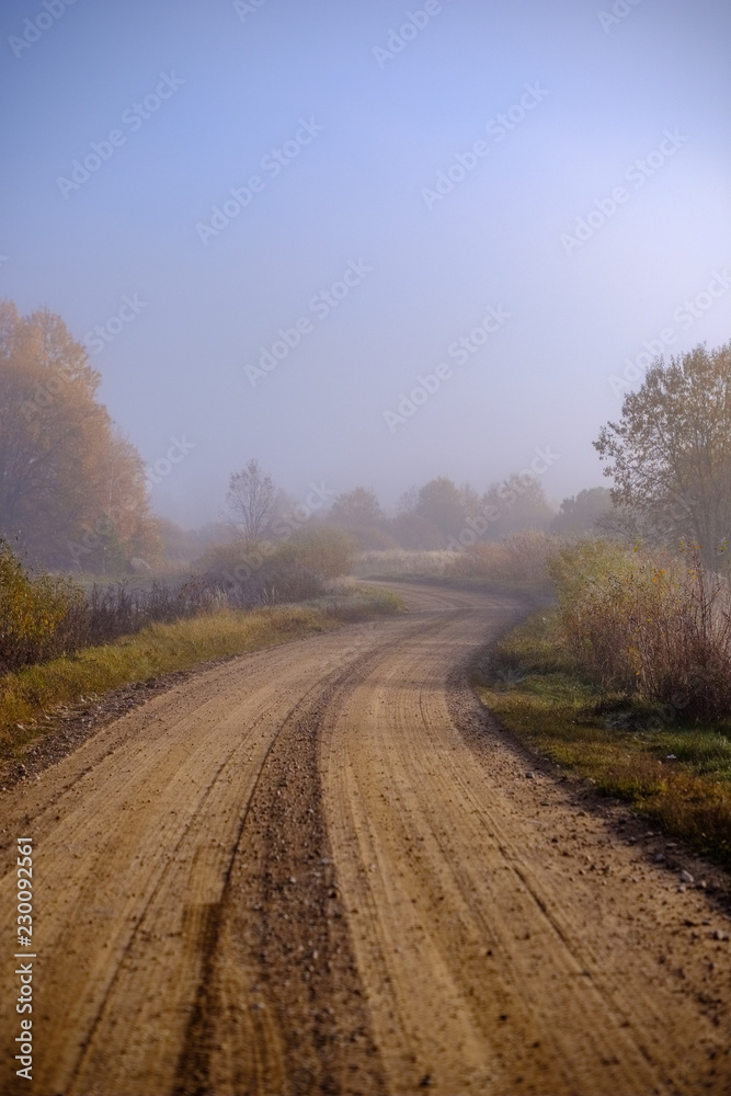 country gravel road in autumn colors in fall colors