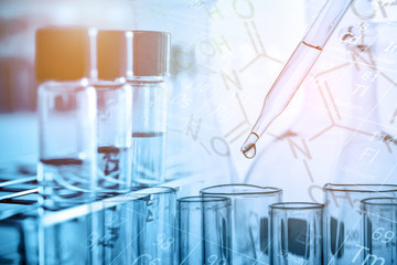 Wall Mural - dropping chemical liquid to test tube with lab glassware, science or chemistry research and developm