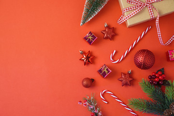 christmas holiday background with decorations and ornaments on red table