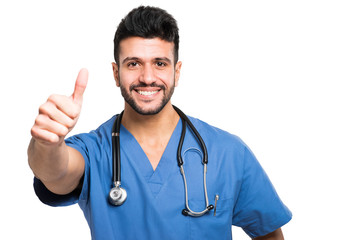 Male nurse isolated on white giving thumbs up