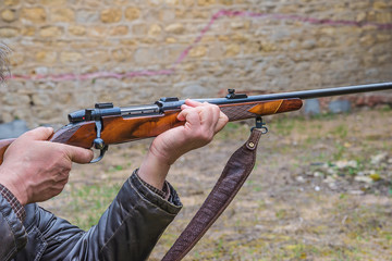 Wall Mural - Men pulling the trigger of hunting carbine