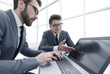 © ASDF - close up.business colleagues using a laptop in the workplace