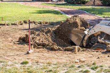 Small Bulldozer Digging In Yard For Pool Installation