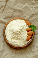 Almond flour in a bowl on brown paper.