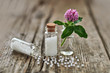 Homeopathic granules and small flowers.