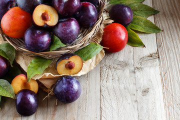 Wall Mural - Fresh plums with leaves