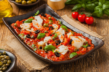 Wall Mural - Cod in Italian in tomatoes with olives and capers.