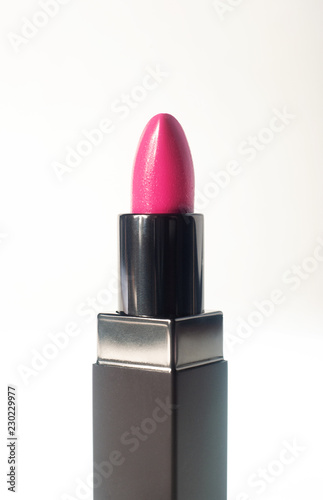 Fotografie, Obraz A bright pink lipstick against a white background